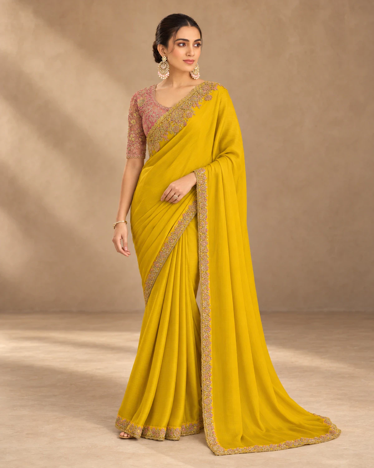 Full-length view of the yellow satin chiffon saree with its scalloped gold border