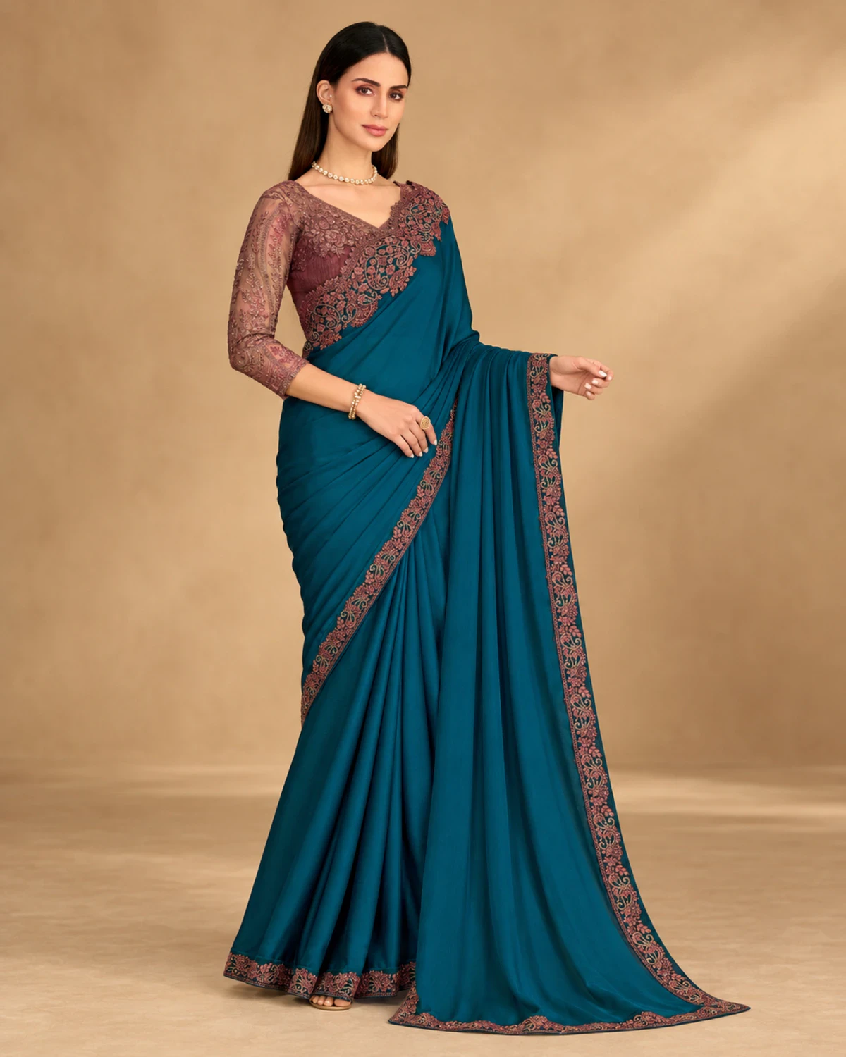 Full-length view of the teal satin chiffon saree with its wine embroidered border