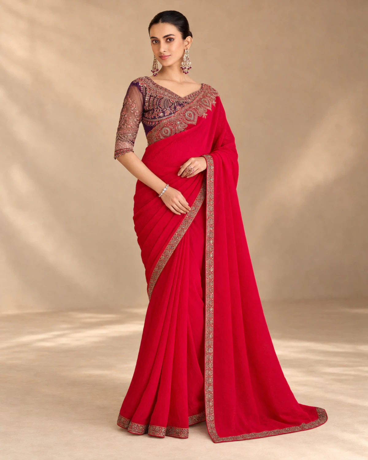 Full-length view of the red satin georgette saree with its gold embroidered border