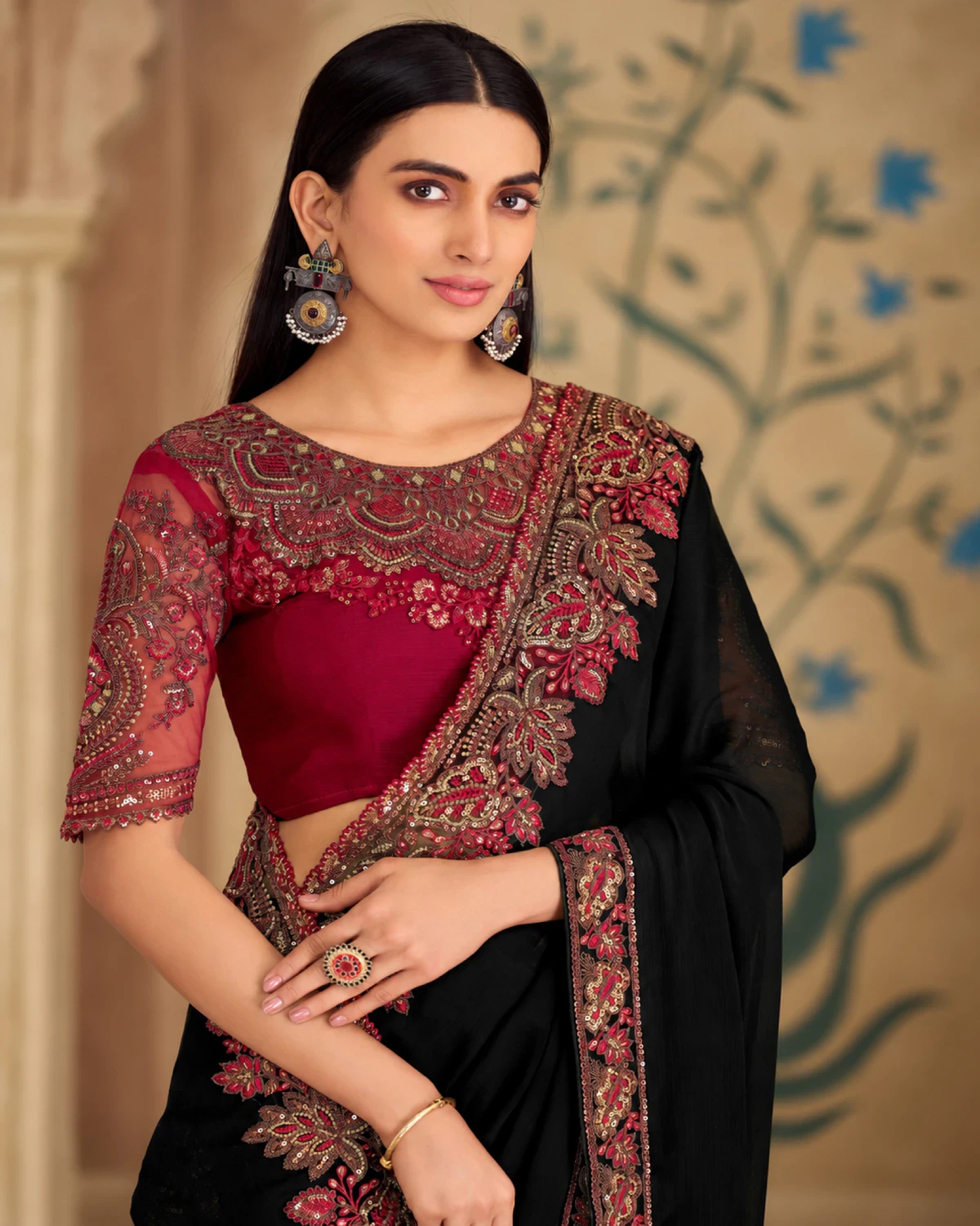 Close-up of the black georgette silk saree's embroidered shoulder and the red embroidered blouse