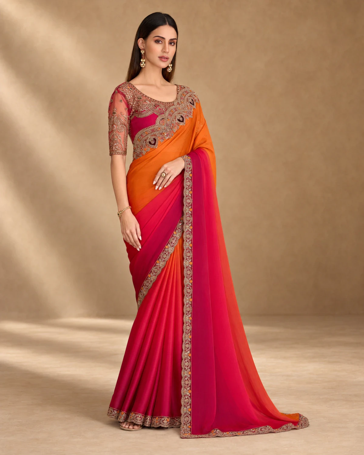 Full-length view of the orange and red shaded satin chiffon saree