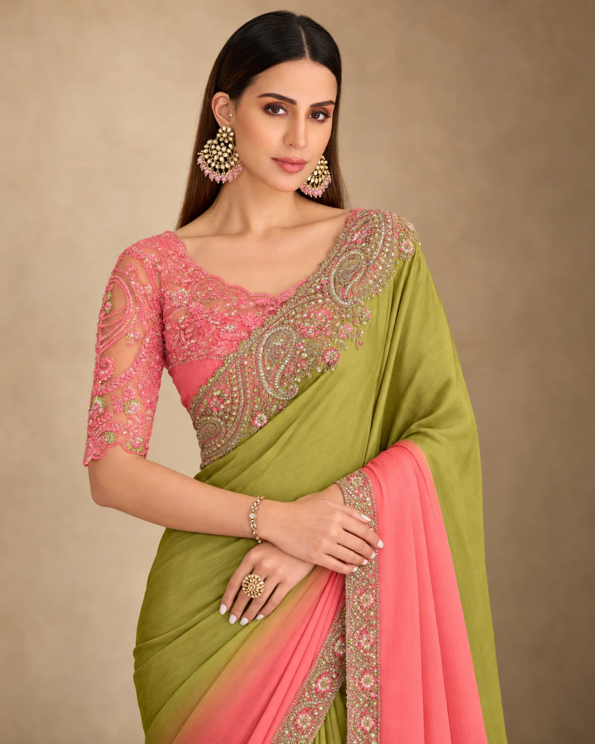 Close-up of the olive and pink crush georgette saree's embroidered shoulder and the pink embroidered blouse