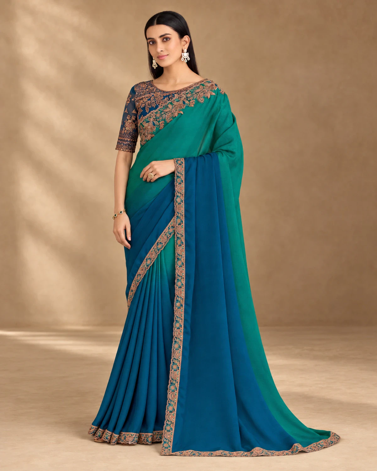 Full-length view of the teal and blue shaded chiffon saree