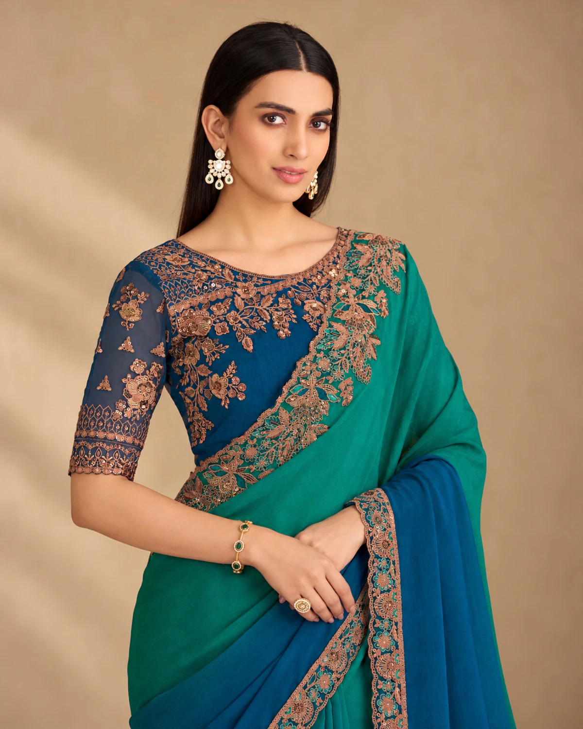 Close-up of the teal and blue chiffon saree's embroidered shoulder and the navy blue embroidered blouse
