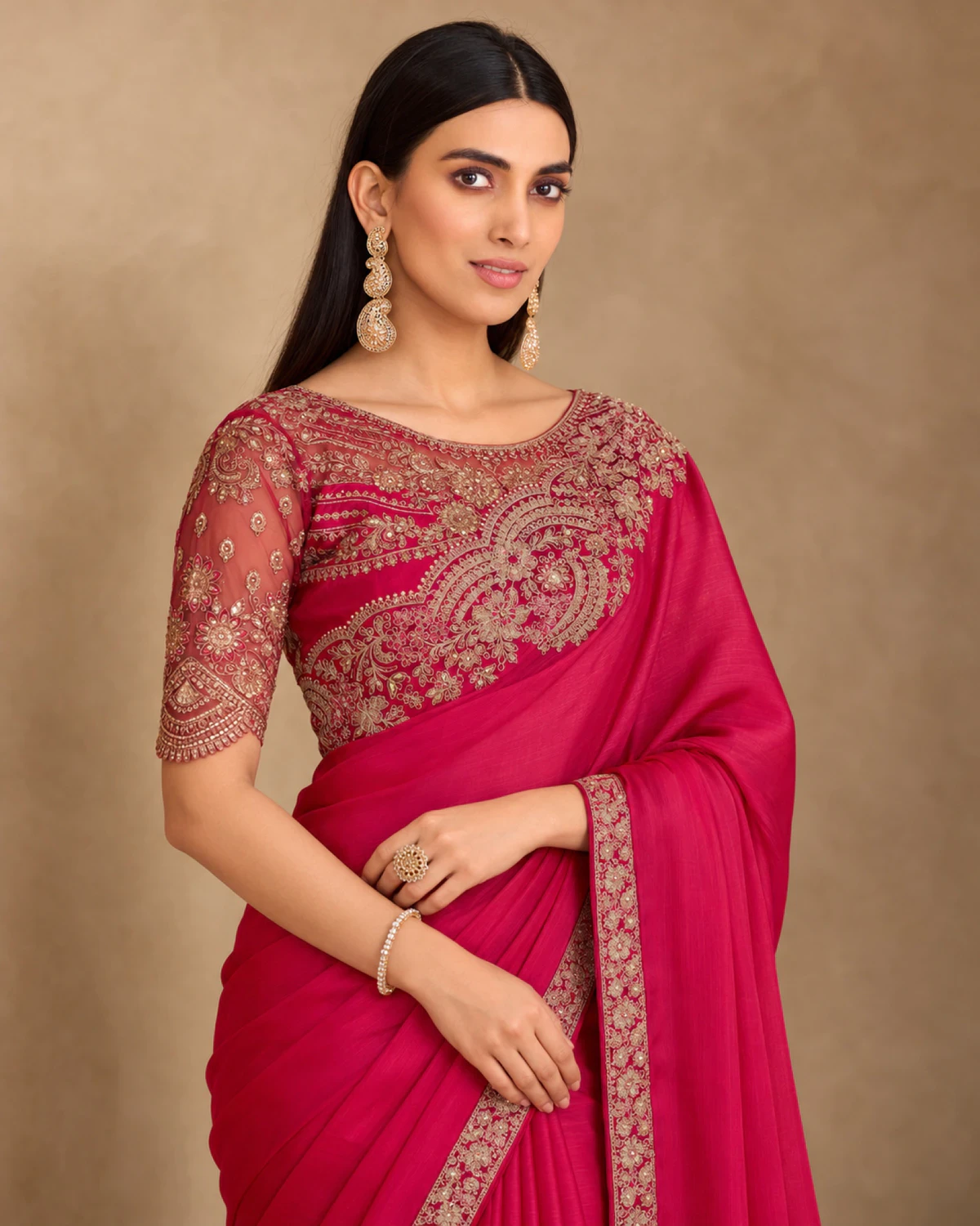 Close-up of the rani pink satin chiffon saree's embroidered shoulder and the rani pink embroidered blouse