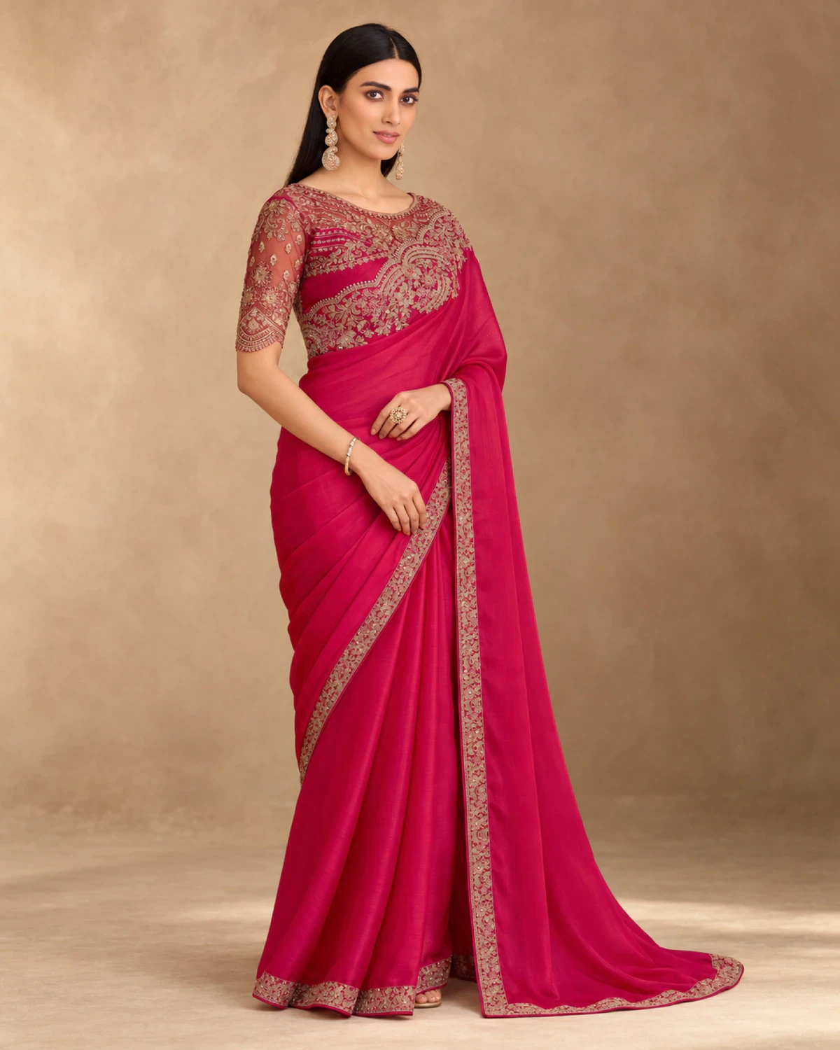Full-length view of the rani pink satin chiffon saree with its gold embroidered border
