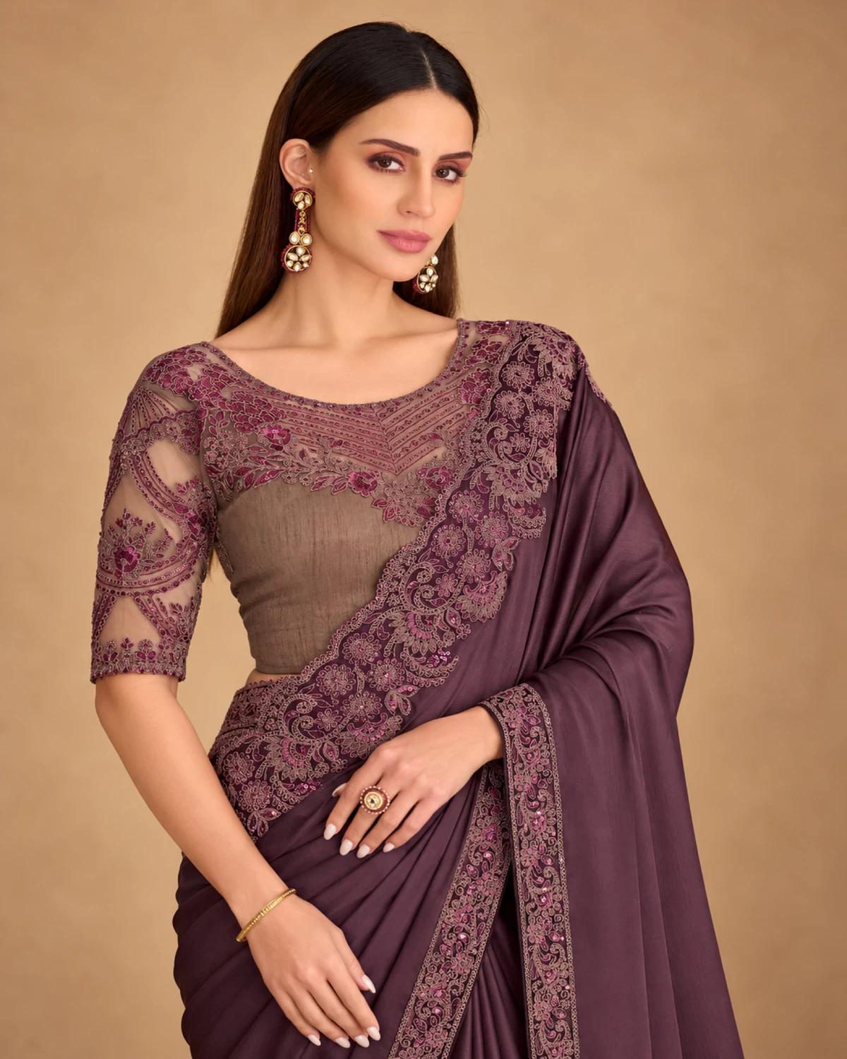 Close-up of the plum satin chiffon saree's embroidered border and the taupe blouse with plum net sleeves