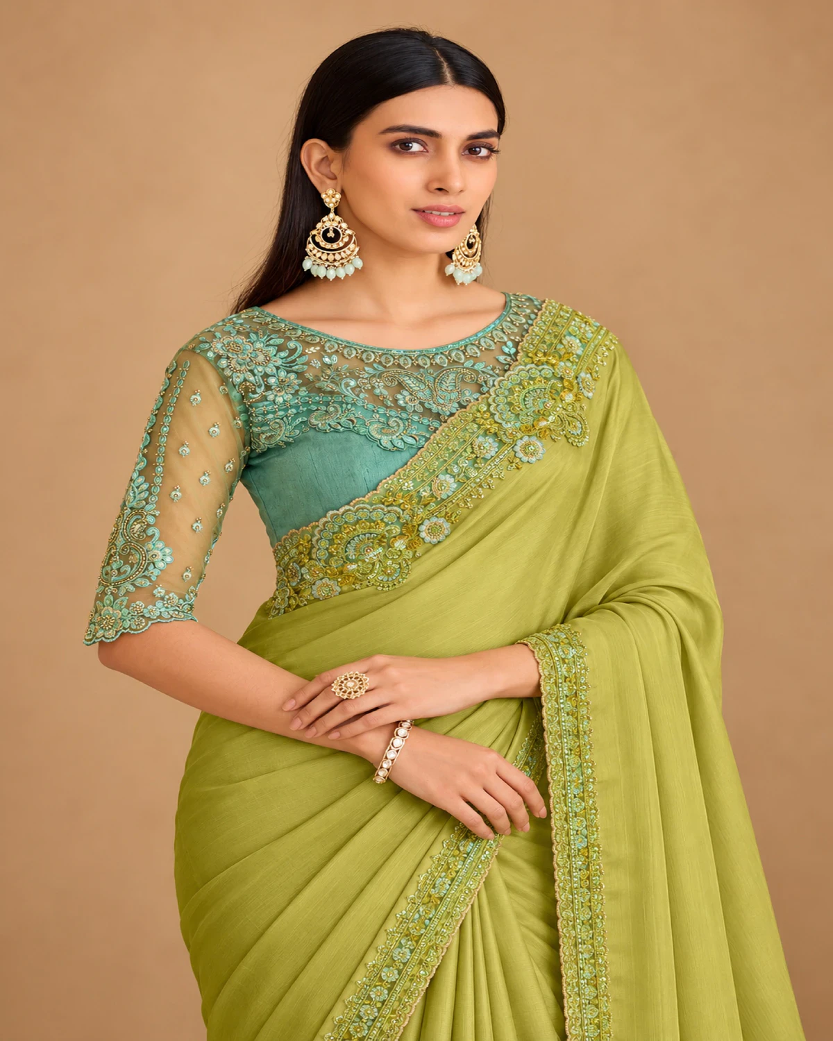Close-up of the lime green satin chiffon saree's embroidered shoulder and the sea green embroidered blouse